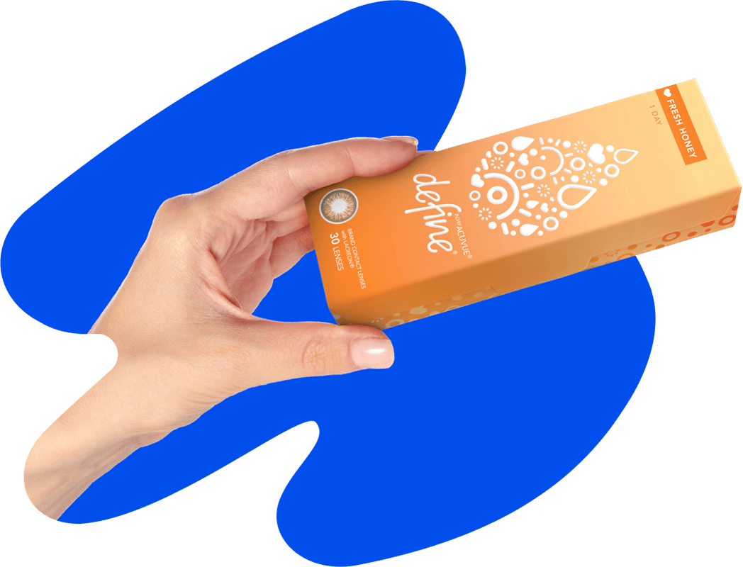A hand holding up a box of Acuvue Define® Fresh